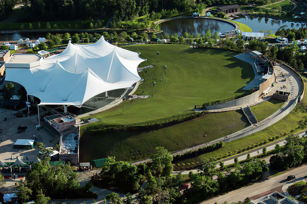 a large white tent on a green field